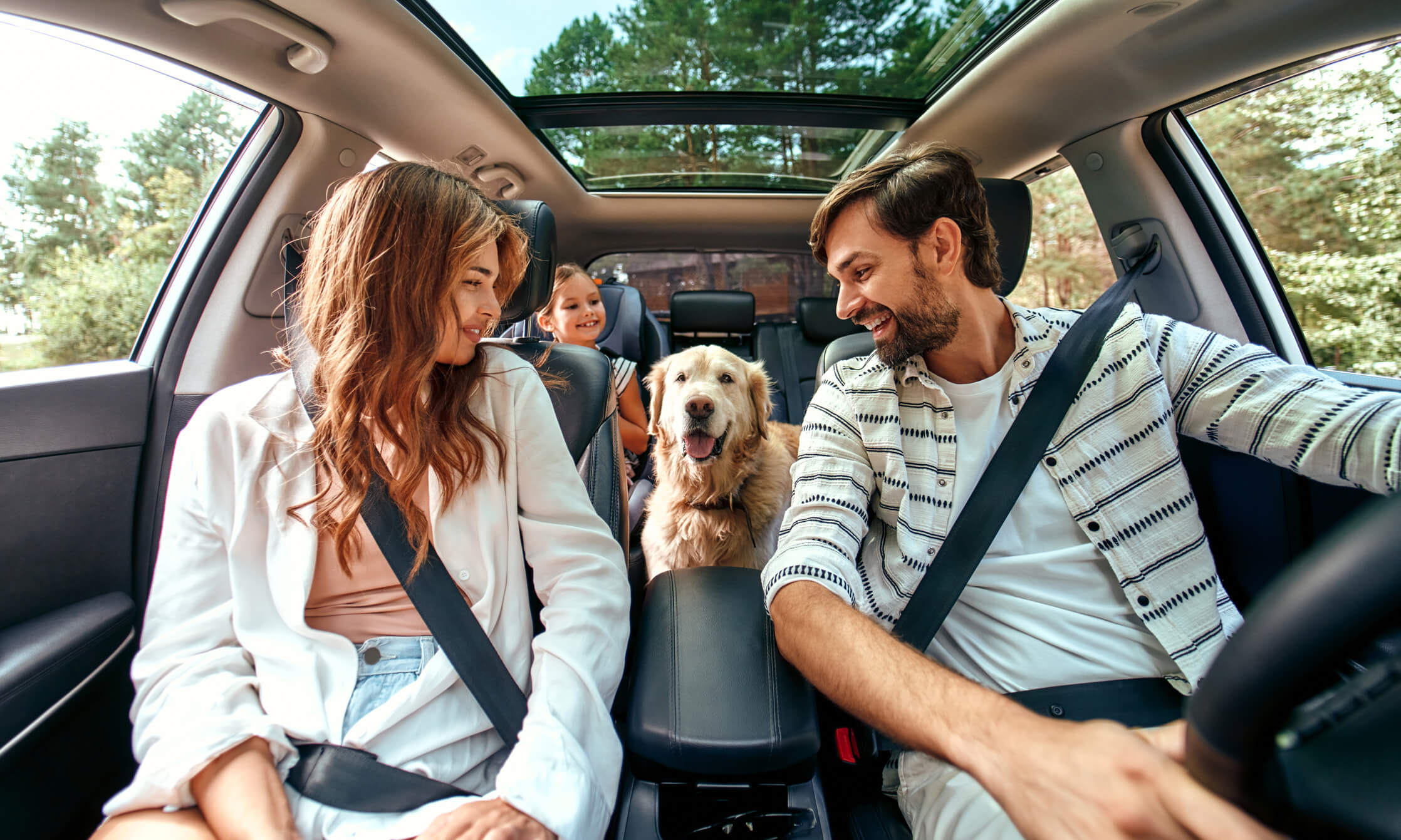 Family inside a car getting ready to go on a road trip